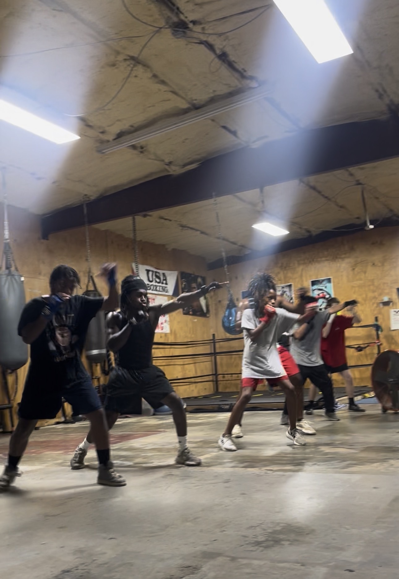 Fit Fighters boxing class shadowboxing together during training