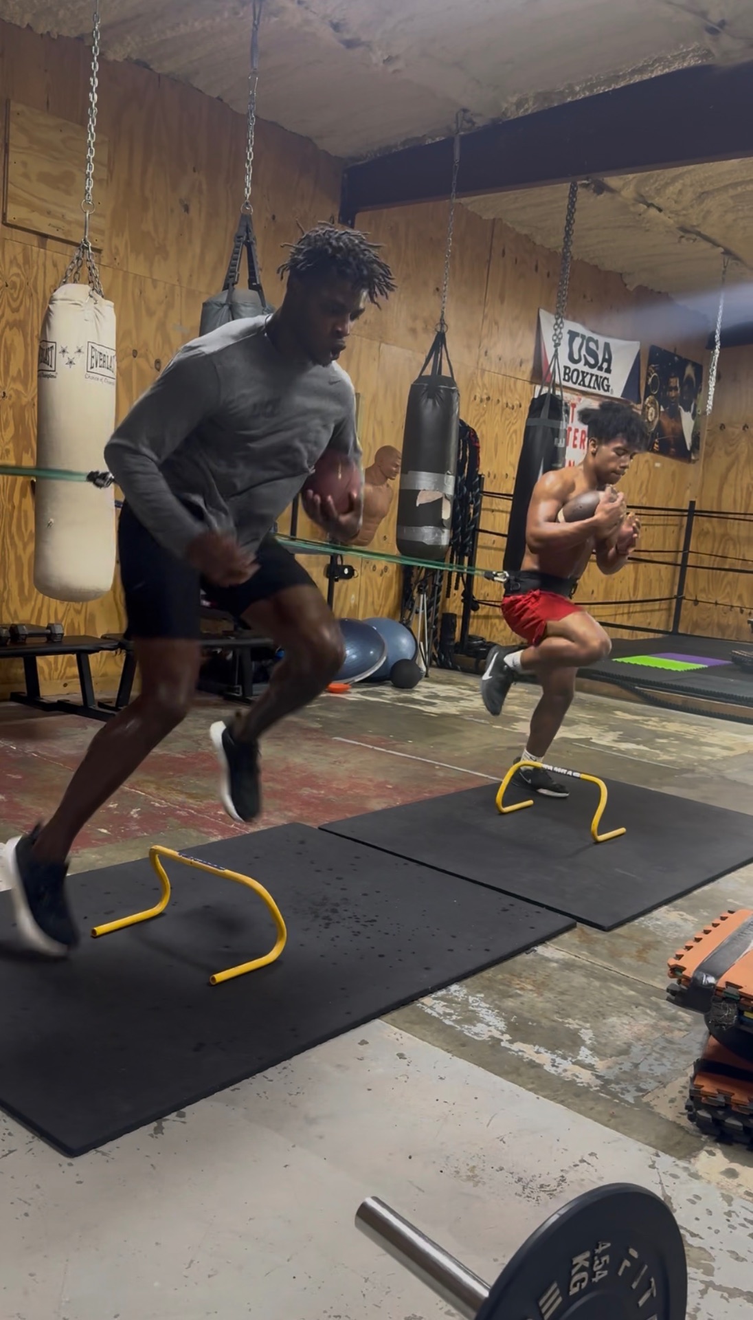 Athletes training speed and explosion over mini hurdles