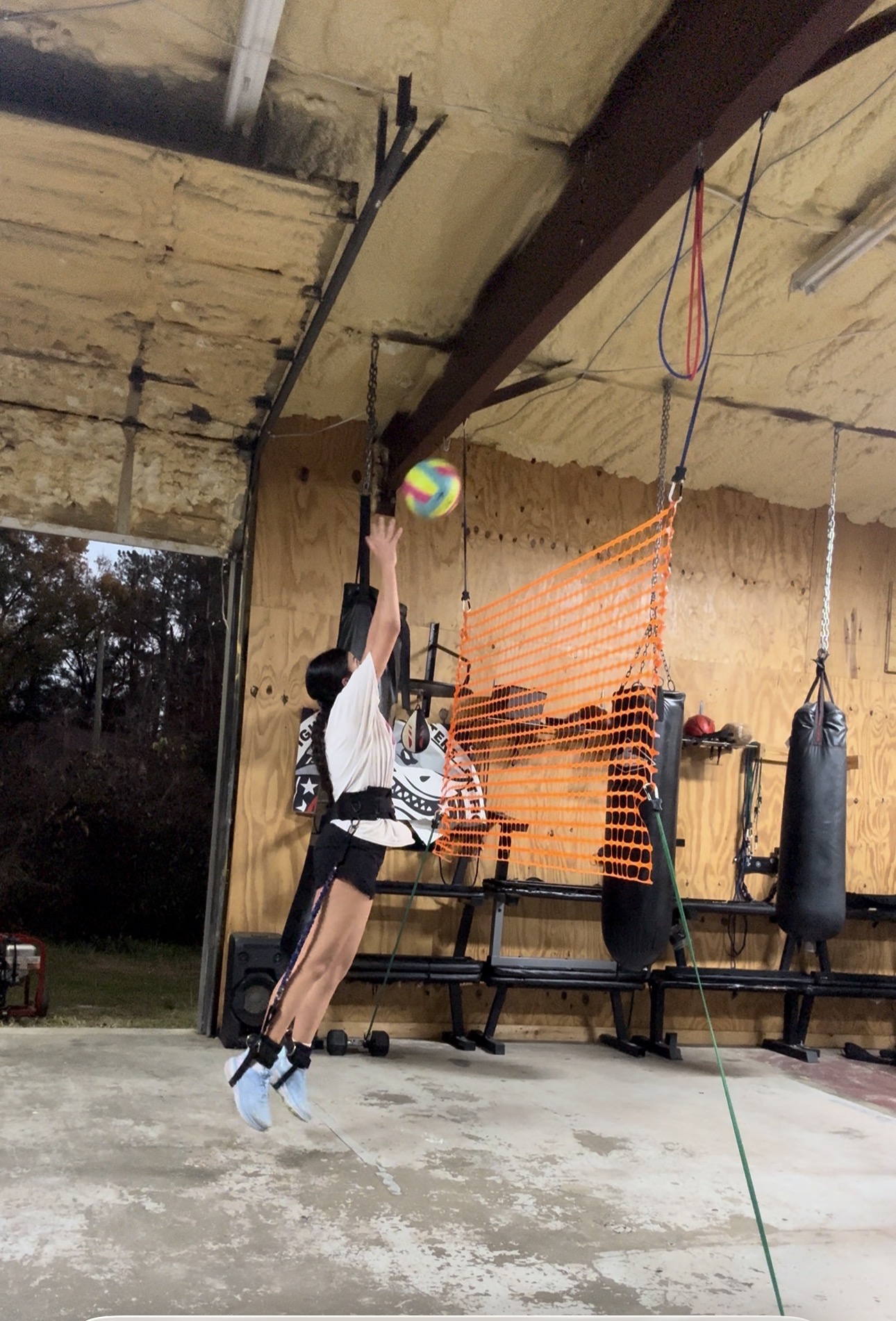 Athletes doing overhead barbell rotational core work