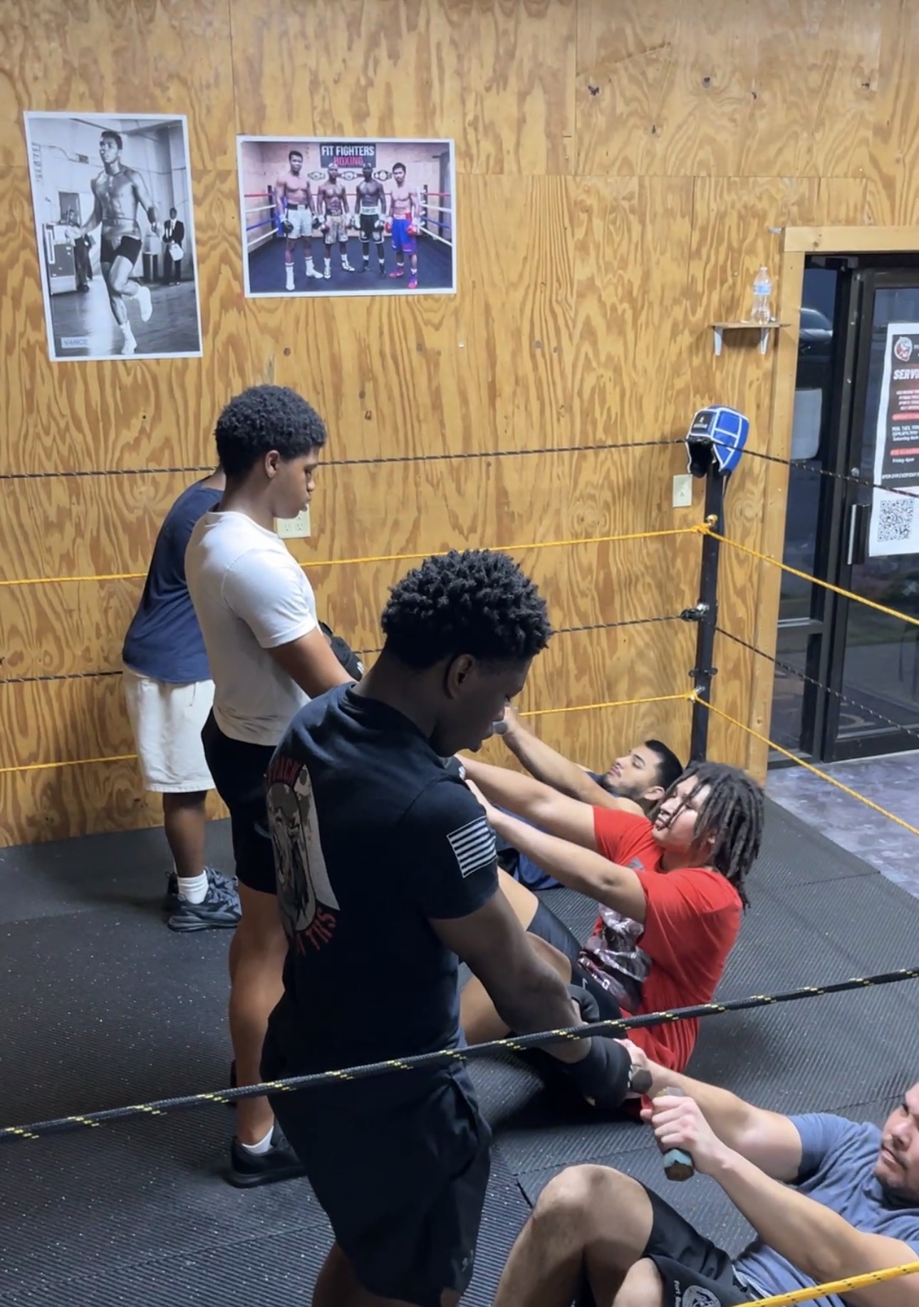 Fit Fighters boxers doing partner core work in the ring
