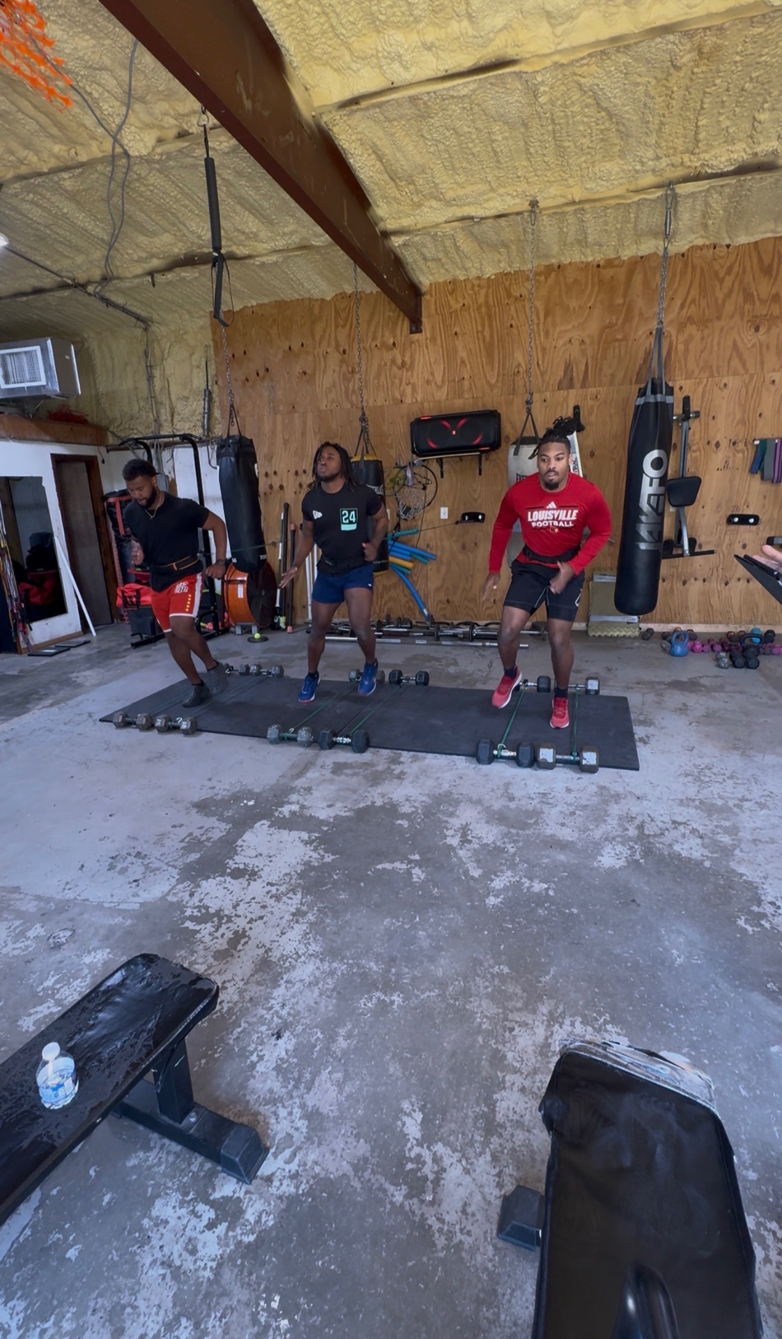 Football players doing banded jump and plyometric drills