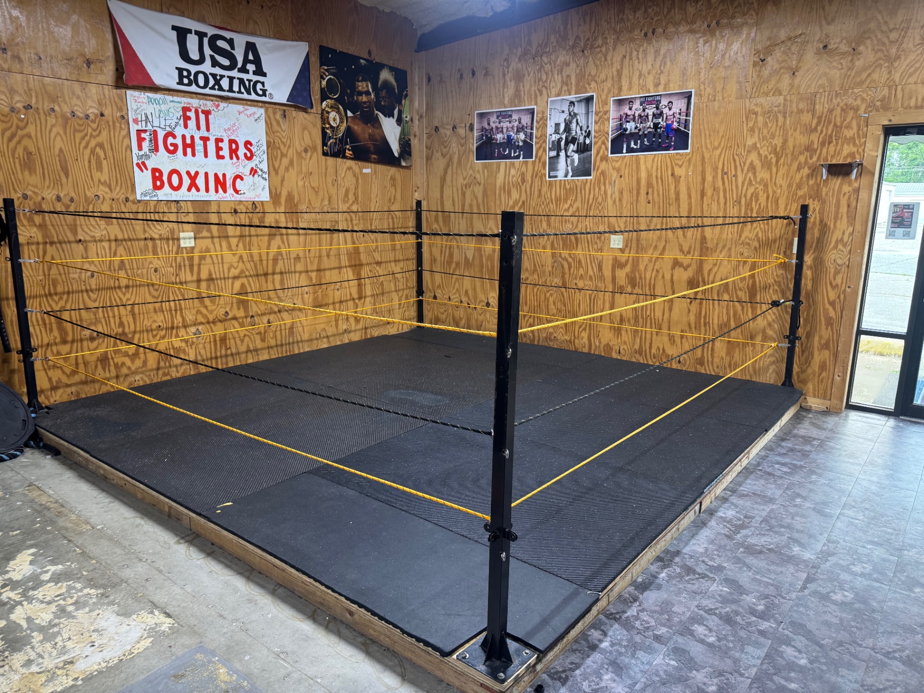 Fit Fighters boxing ring inside the gym with USA Boxing banner