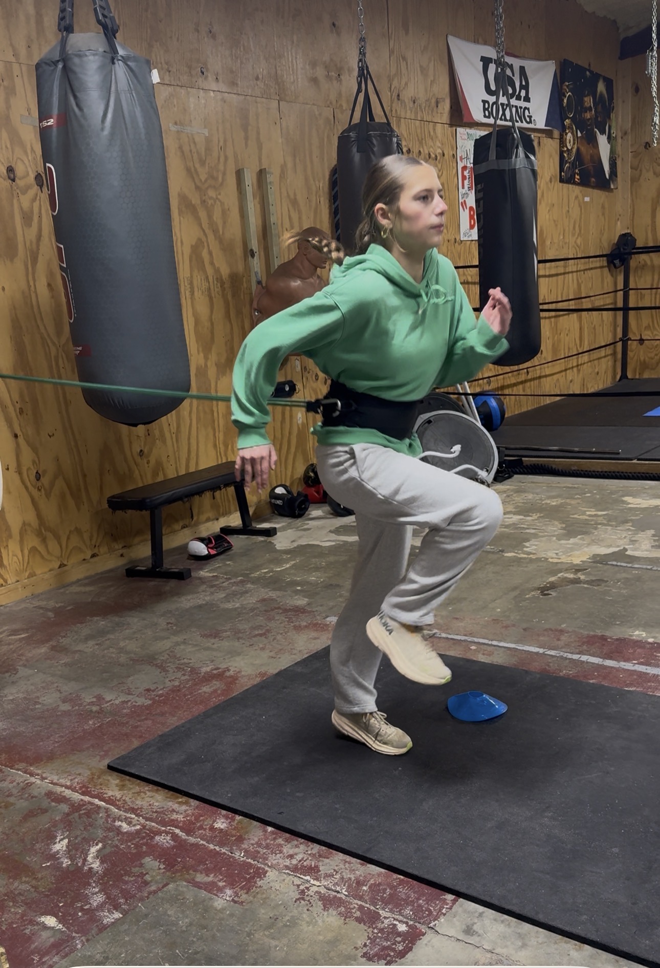 Athlete doing resistance-band single-leg strength work