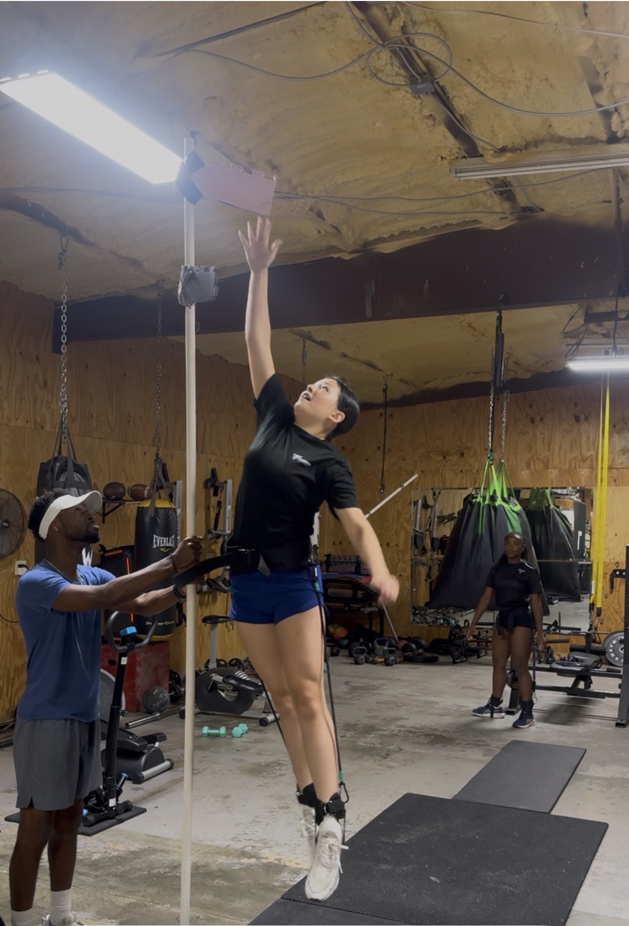 Volleyball athlete training vertical jump and reach with Coach Dom