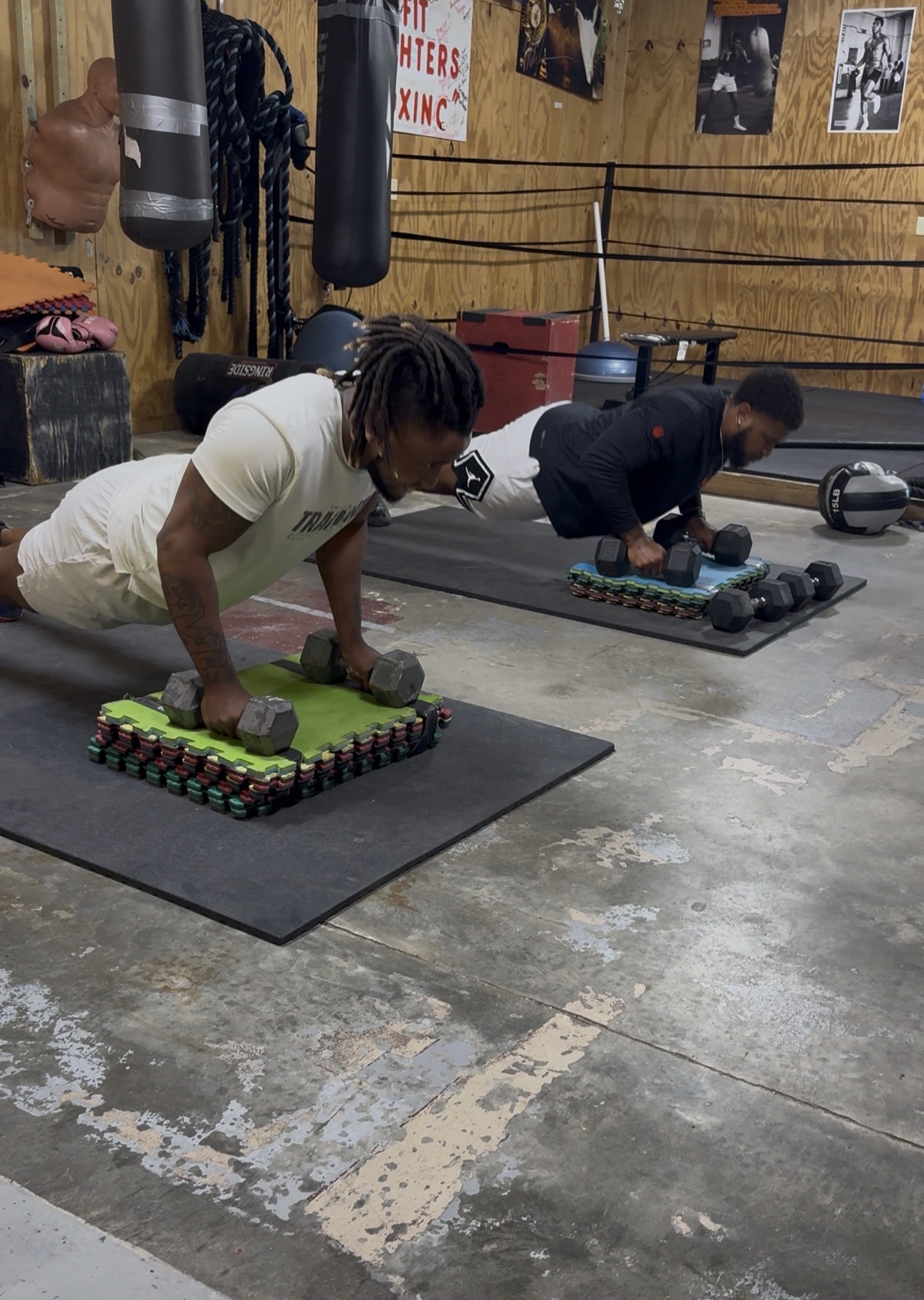 Athletes doing dumbbell push-ups during strength training