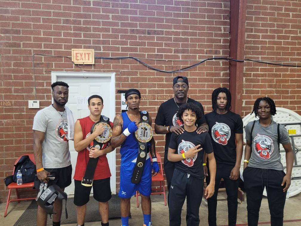 Fit Fighters amateur boxing team with championship belts