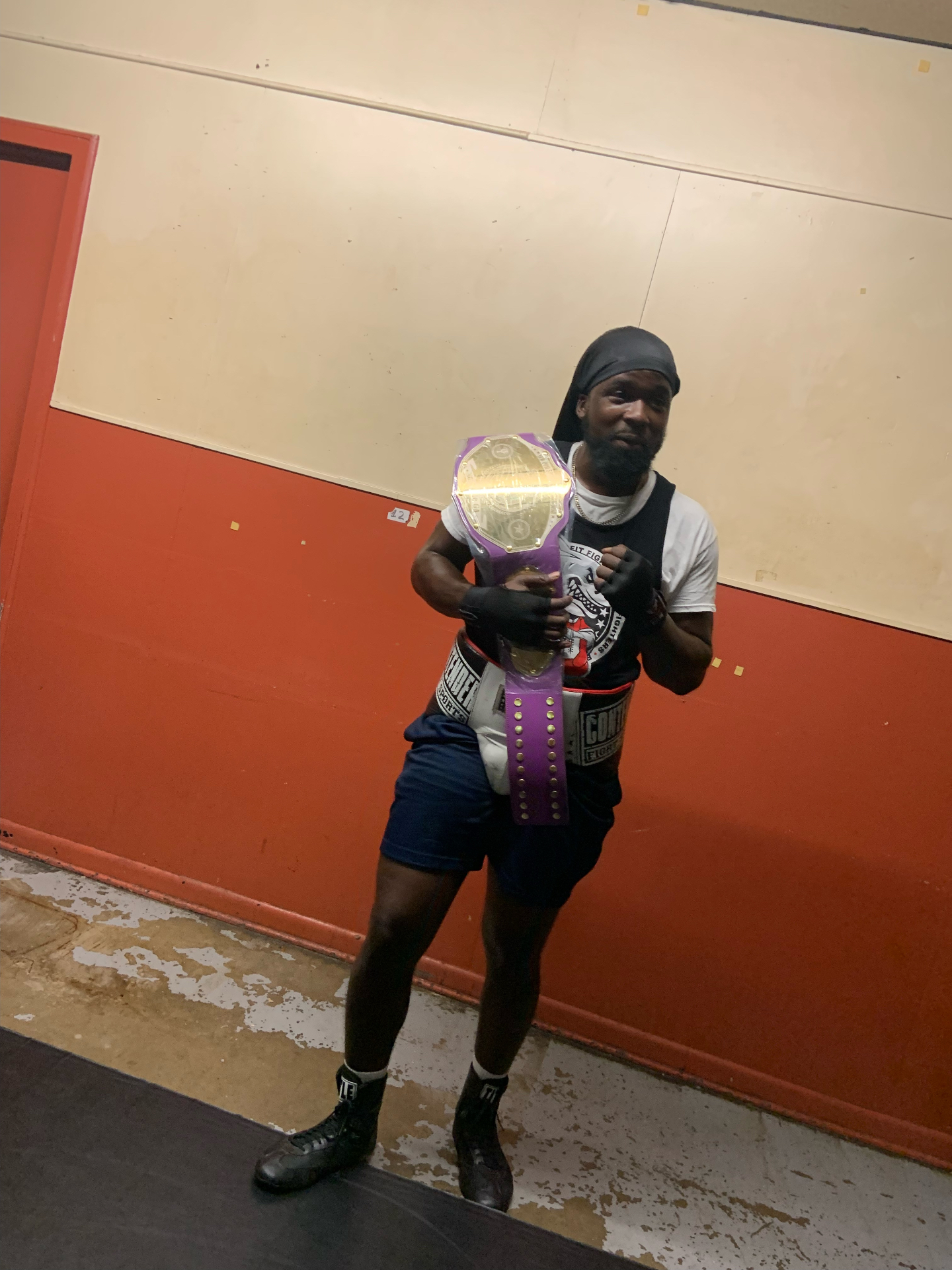Fit Fighters boxer with championship belt after a win